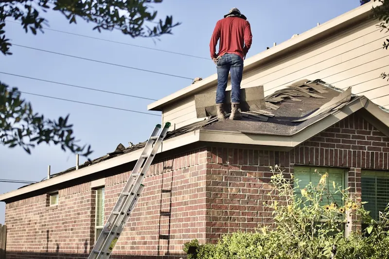 Professional roofer working on a residential roof in Randolph